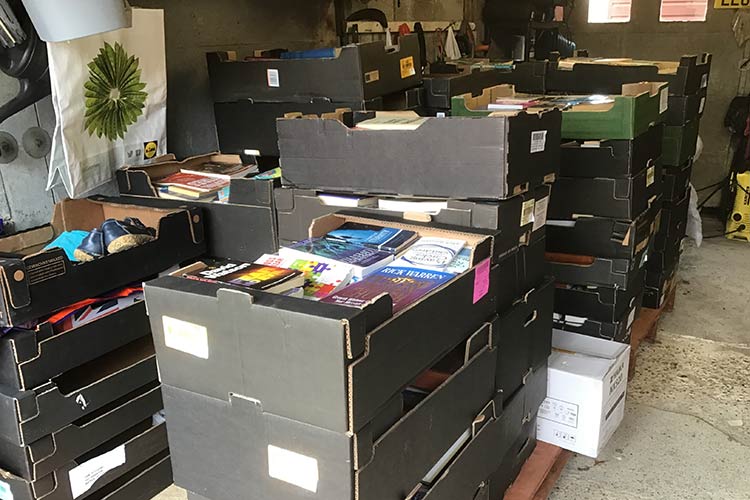 boxes of donated books in a garage